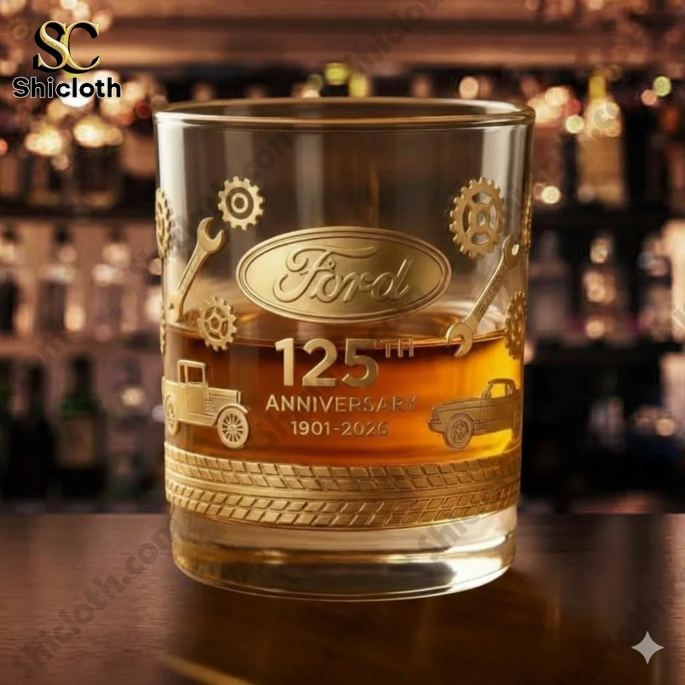 A Ford anniversary whiskey glass with golden engravings on a bar table!