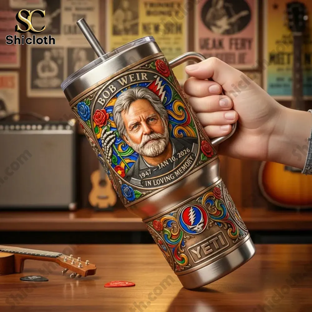 Grateful Dead Bob Weir Your Music Lives On 1947-2026 Tumbler 3 Hand holding Grateful Dead Bob Weir tumbler in music studio setting.