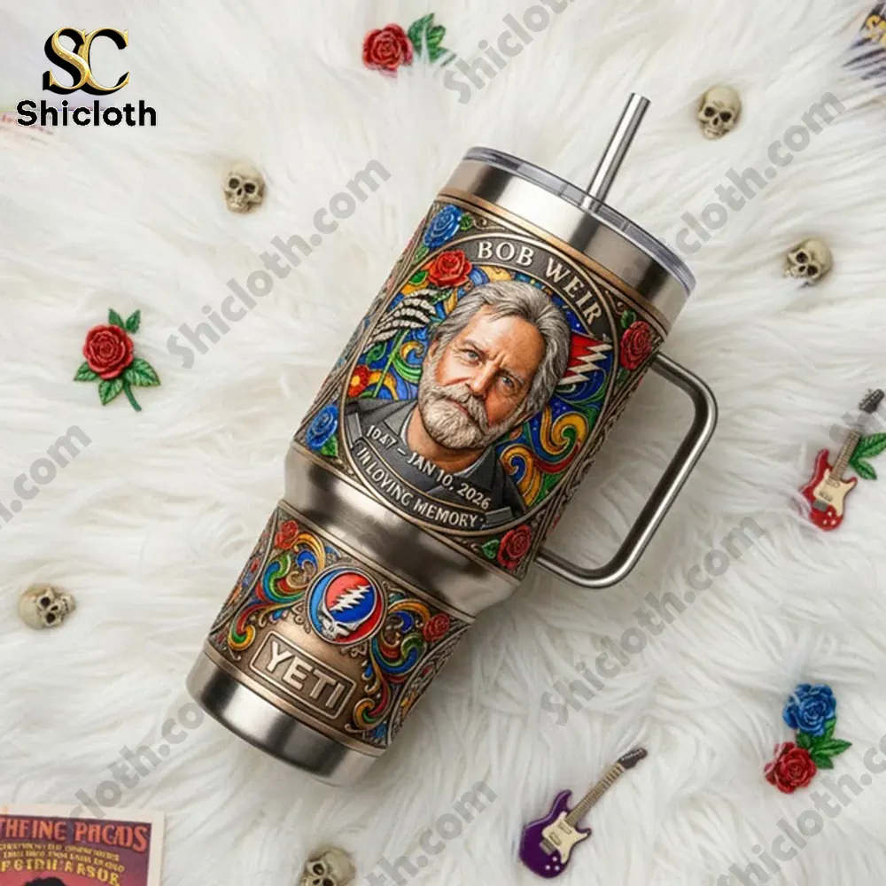 Grateful Dead Bob Weir Your Music Lives On 1947-2026 Tumbler 4 Grateful Dead Bob Weir tumbler resting on white fur with music decorations.