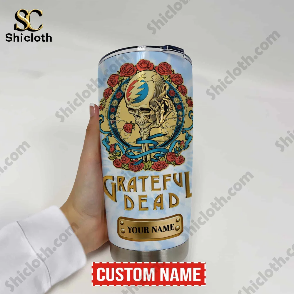 Hand holding Grateful Dead stainless tumbler with skull artwork!