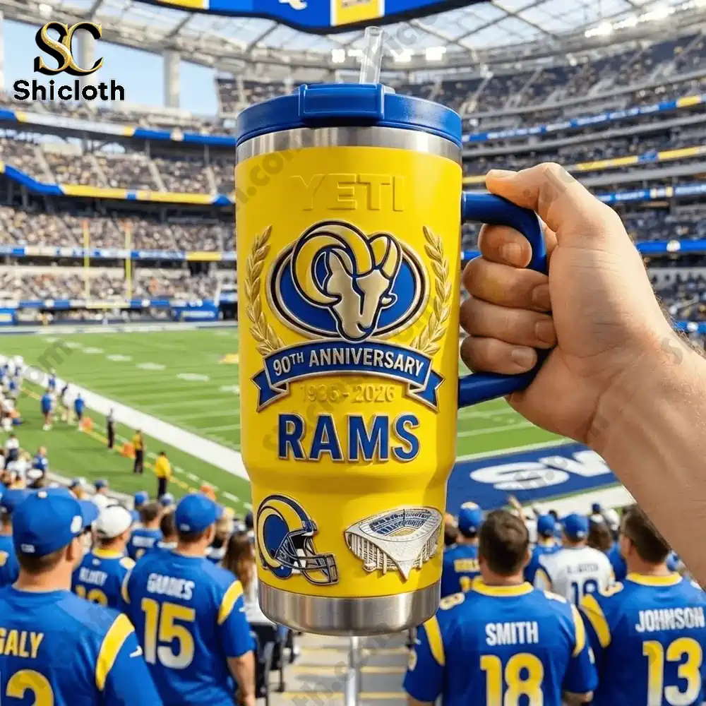 Hand holding yellow Yeti Rams mug inside football stadium!