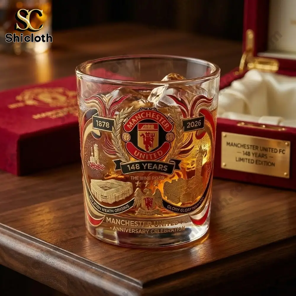 Close up of Manchester United anniversary whiskey glass on a wooden table!