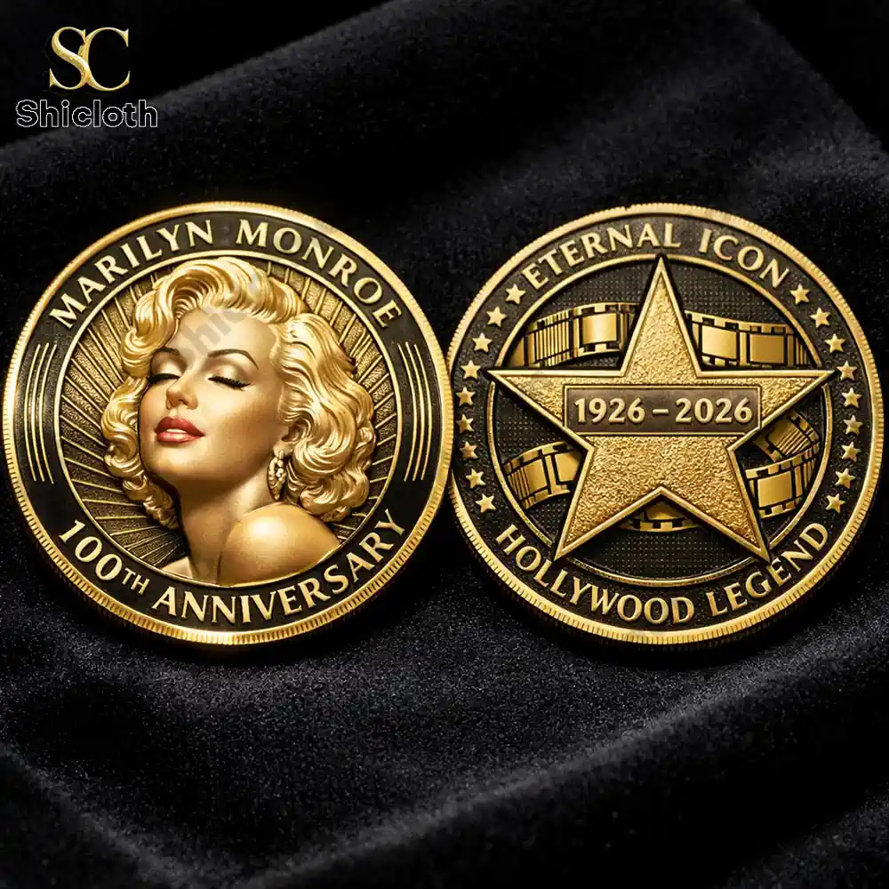 Two gold commemorative coins for Marilyn Monroe's 100th anniversary 1926–2026 displayed on black velvet fabric.