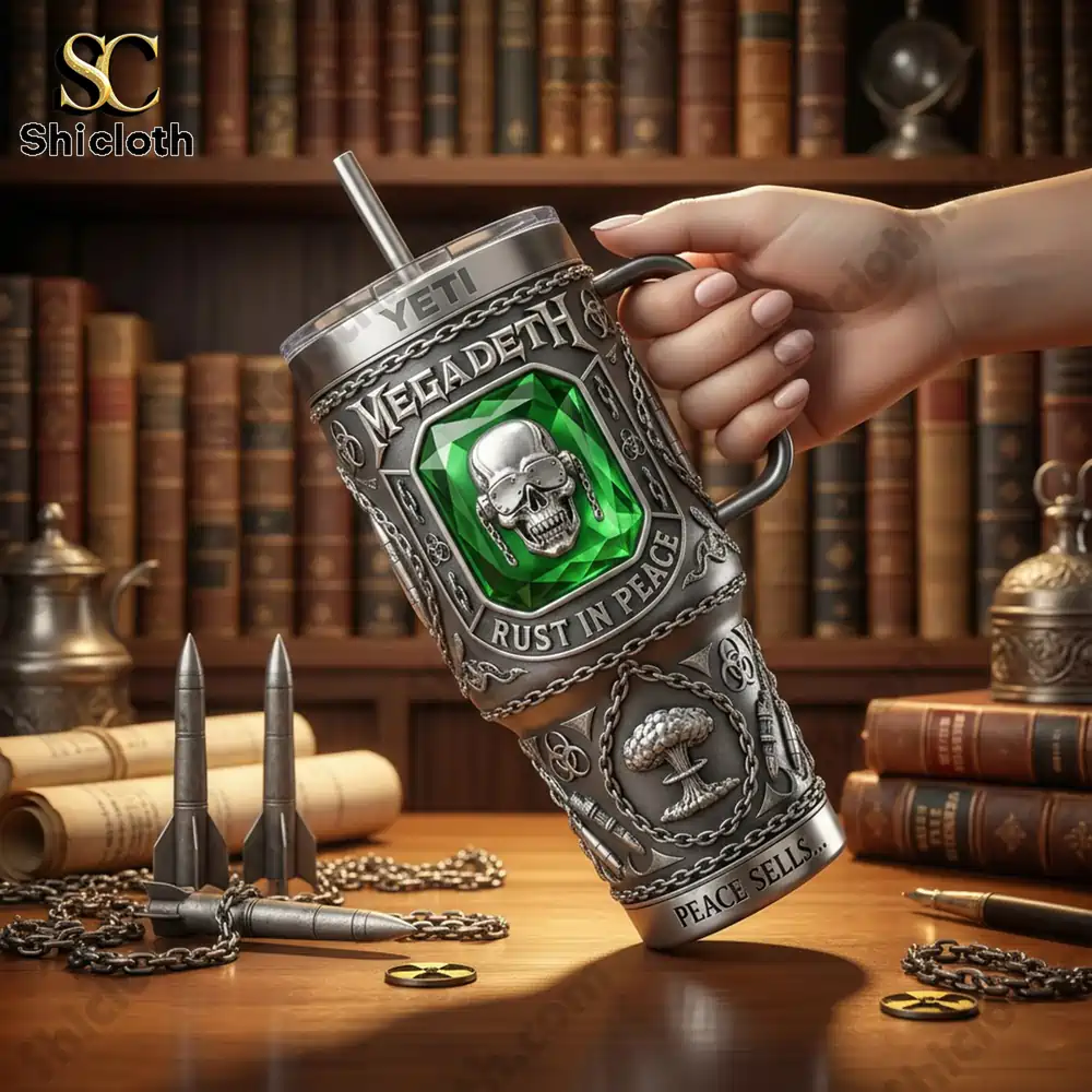 Hand holding Megadeth metal tumbler with skull green gem on wooden table!