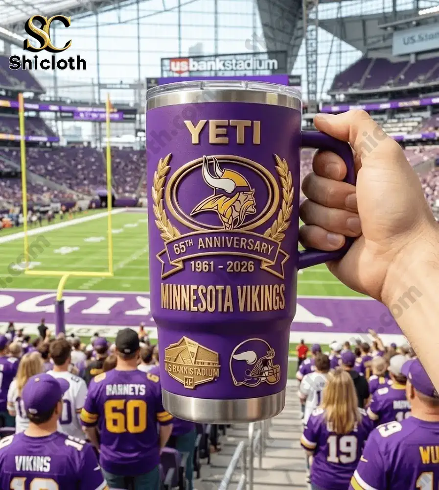 Hand holding YETI Minnesota Vikings anniversary mug during game!