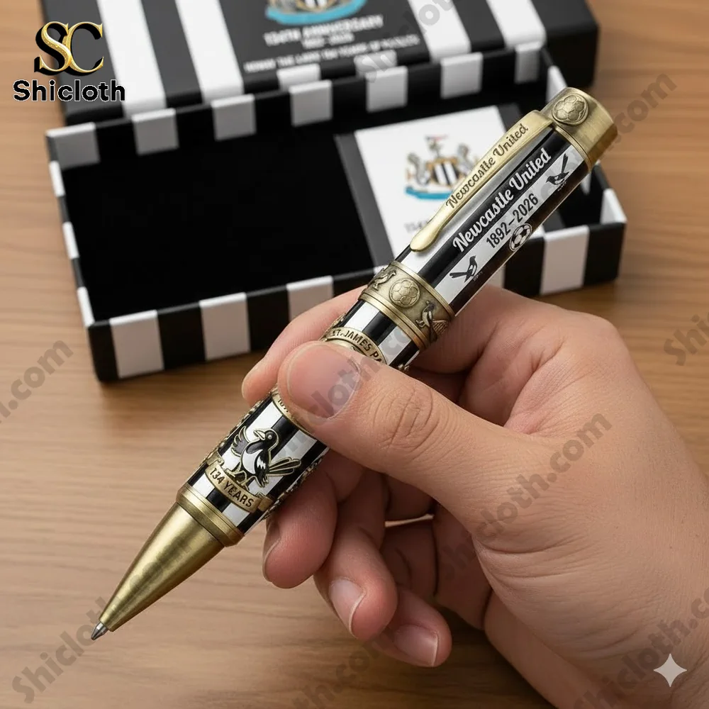Newcastle United anniversary pen held in hand with black and white gift box
