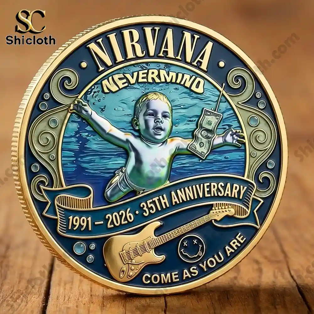 Nirvana Nevermind 35th Anniversary Coin 3 Two Nirvana themed commemorative coins displayed on a wooden table!