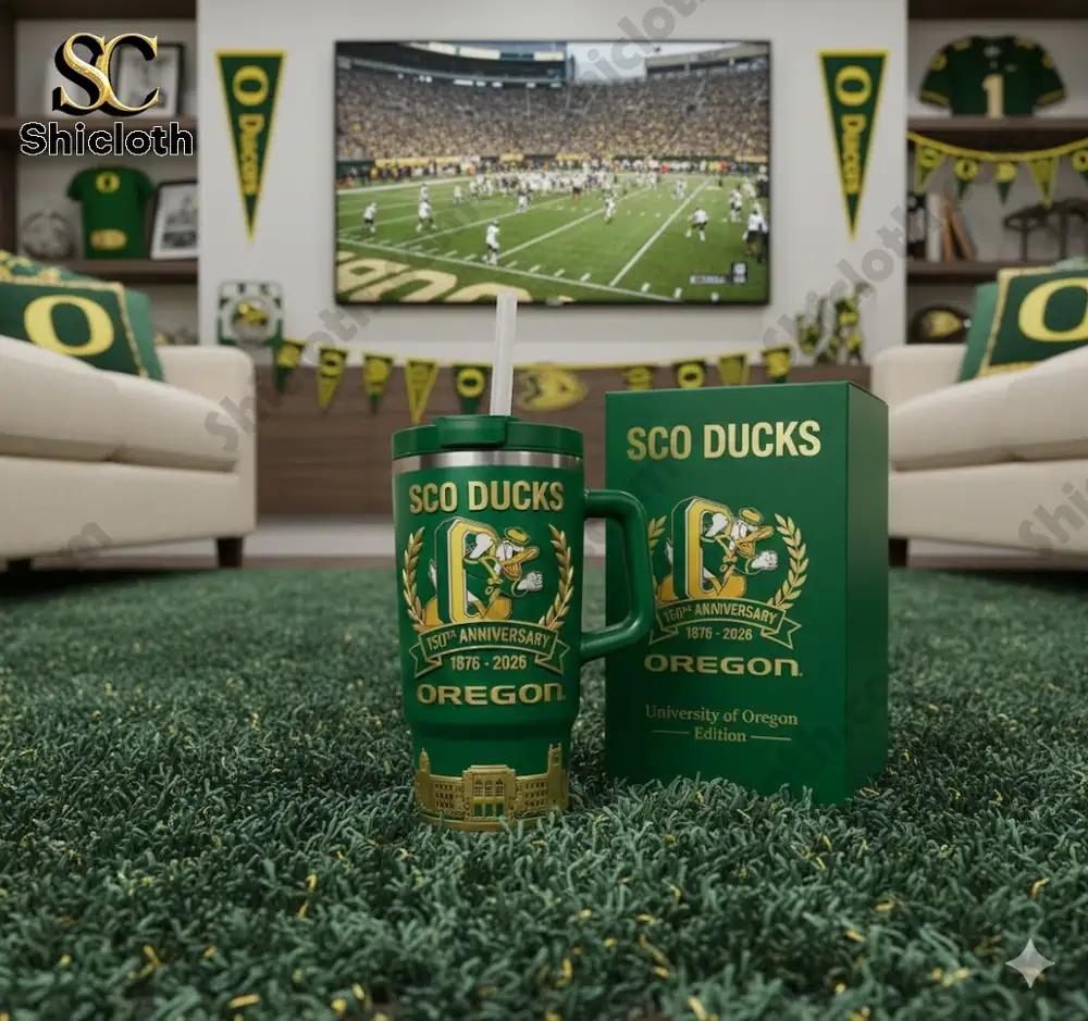 Green Oregon Ducks tumbler with handle and straw displayed in a themed living room by Shicloth!