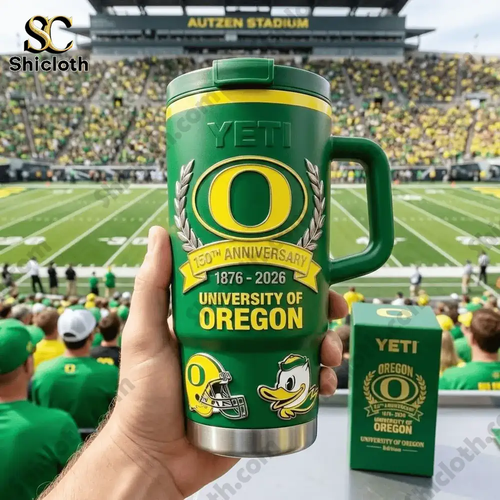 Hand holding green Yeti Oregon tumbler in stadium!