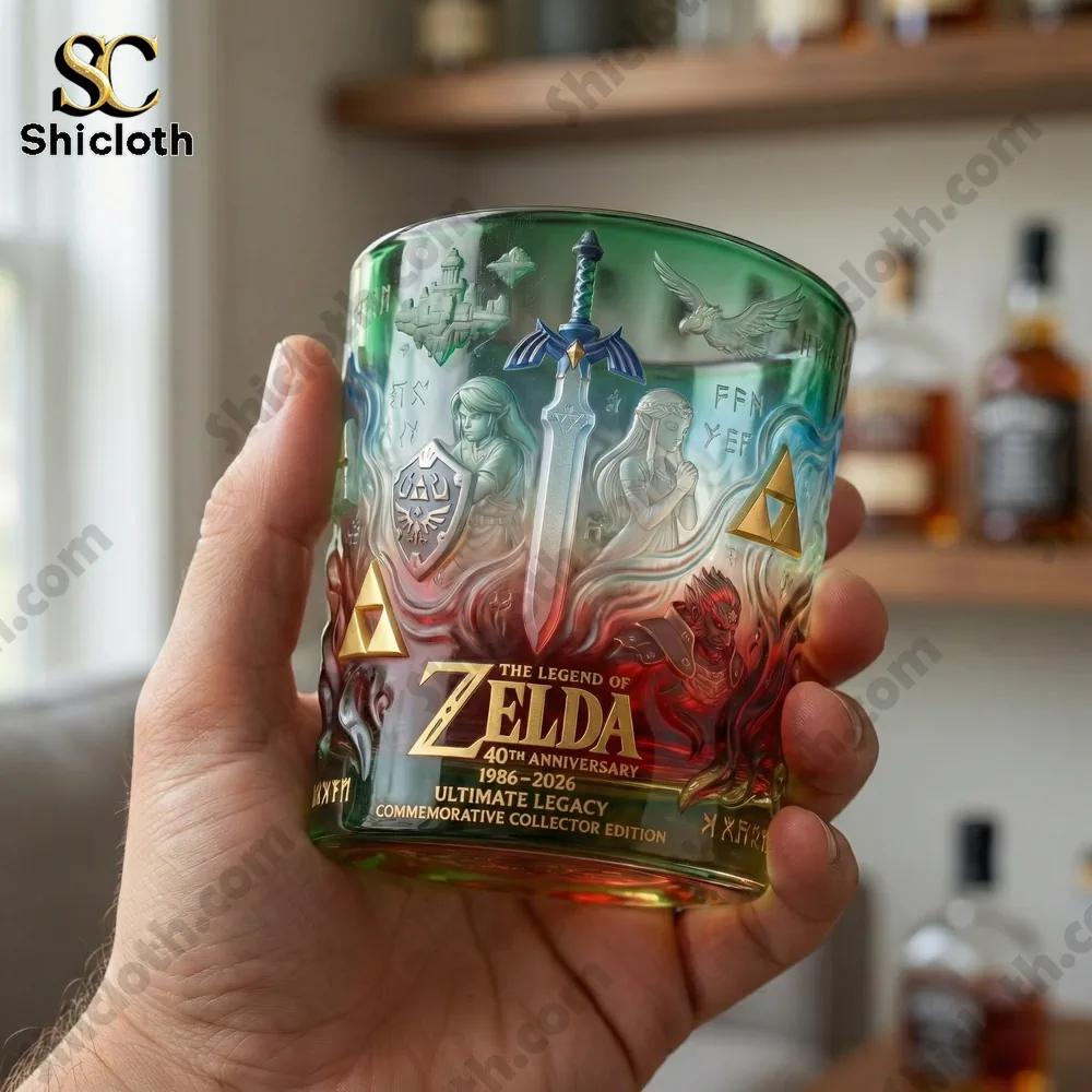 Hand holding a Zelda anniversary whisky glass with detailed artwork!