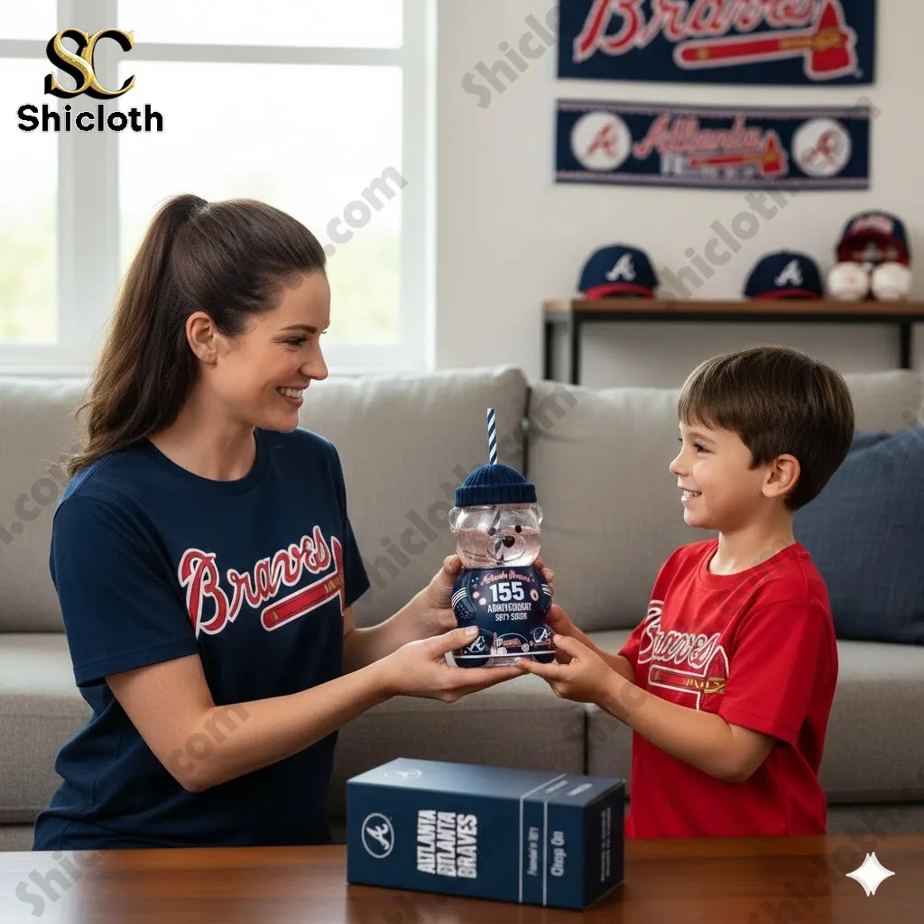 Mother and son holding an Atlanta Braves 155th anniversary bear shaped tumbler in a living room.