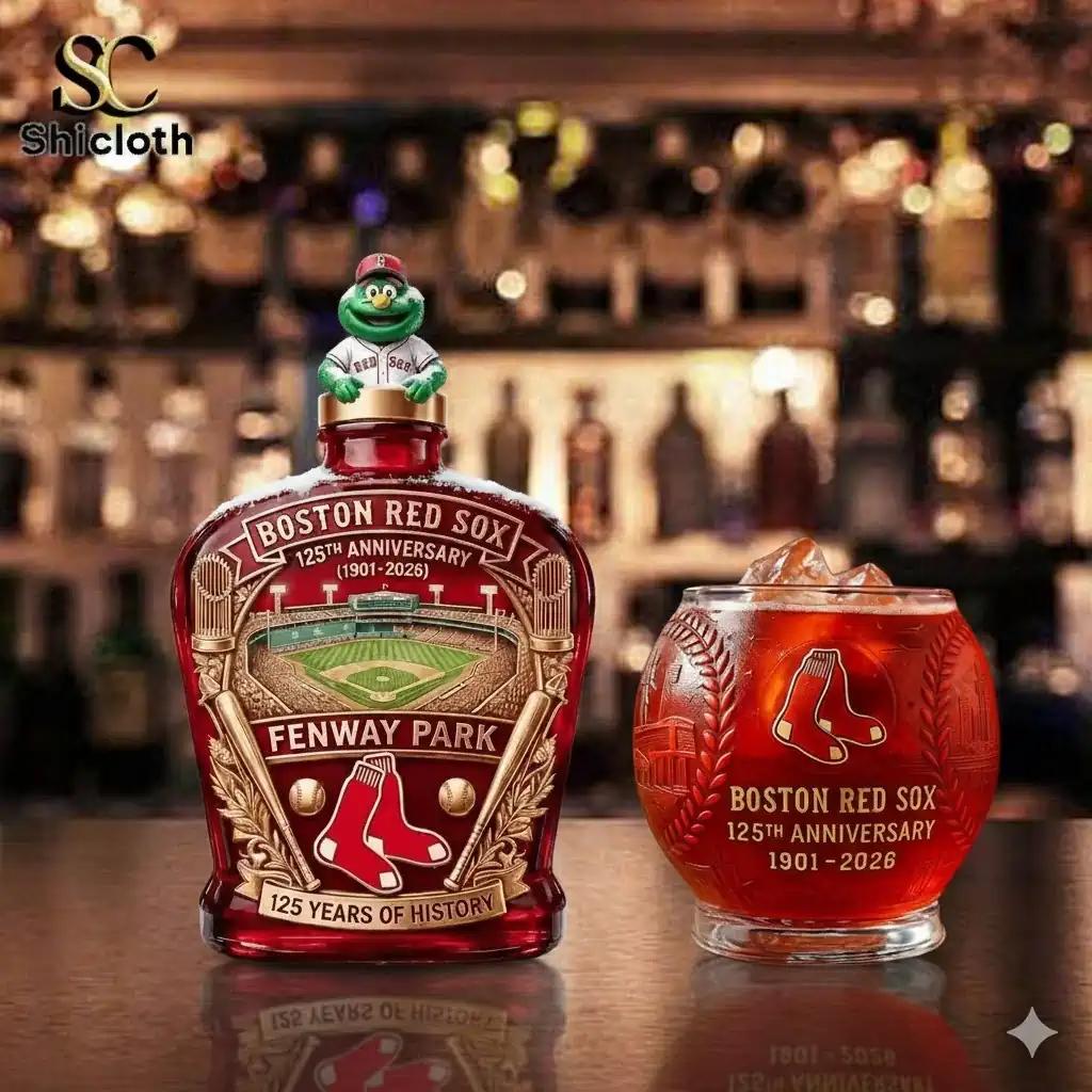 Boston Red Sox 125th anniversary whiskey bottle with matching glass on a bar counter.