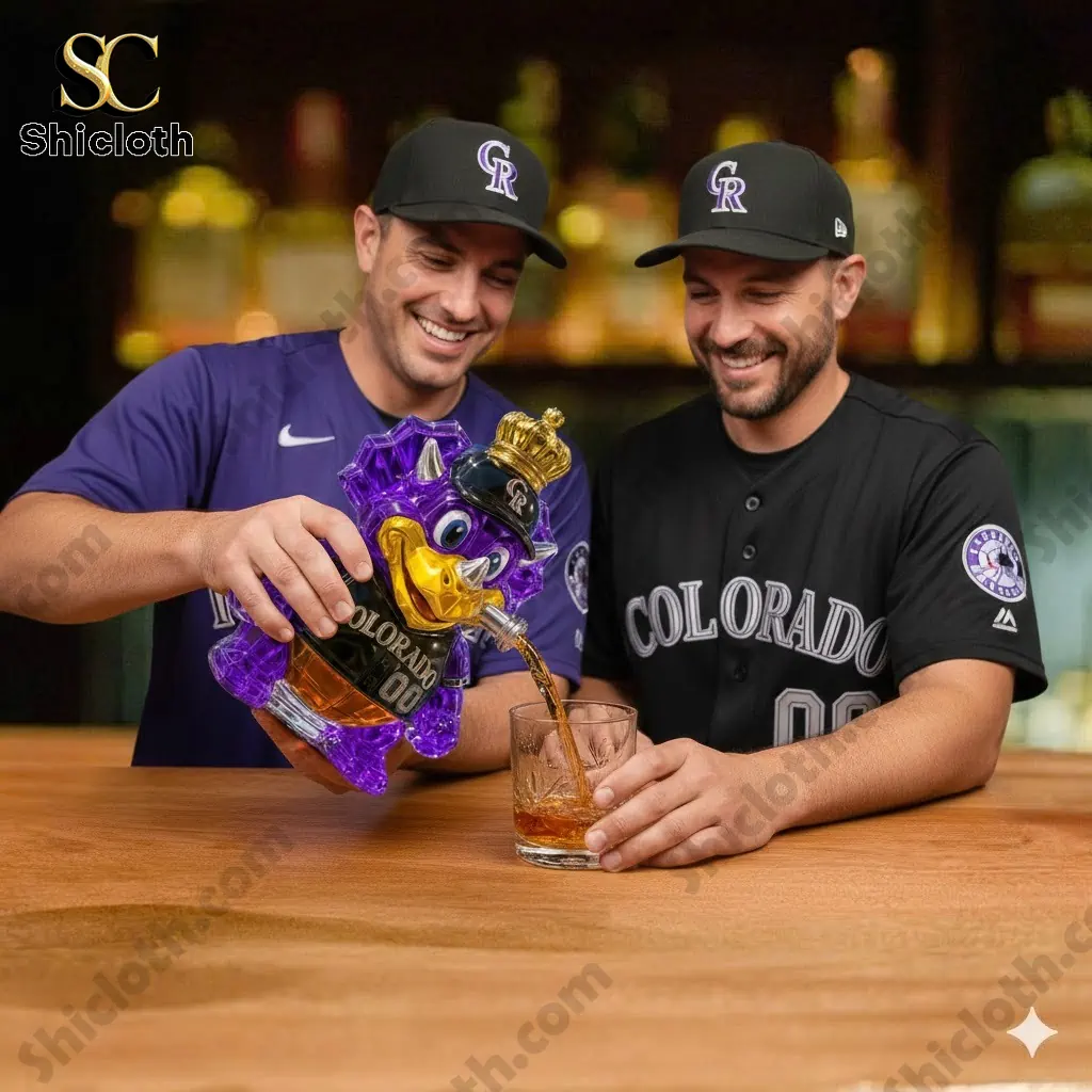 Two Colorado Rockies players pouring whiskey from a purple dinosaur bottle into a glass.