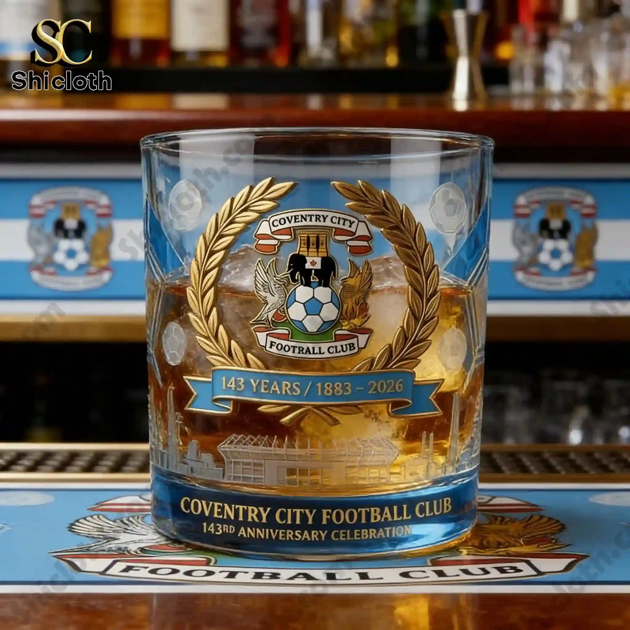 Coventry City anniversary whiskey glass filled with ice on a bar counter!