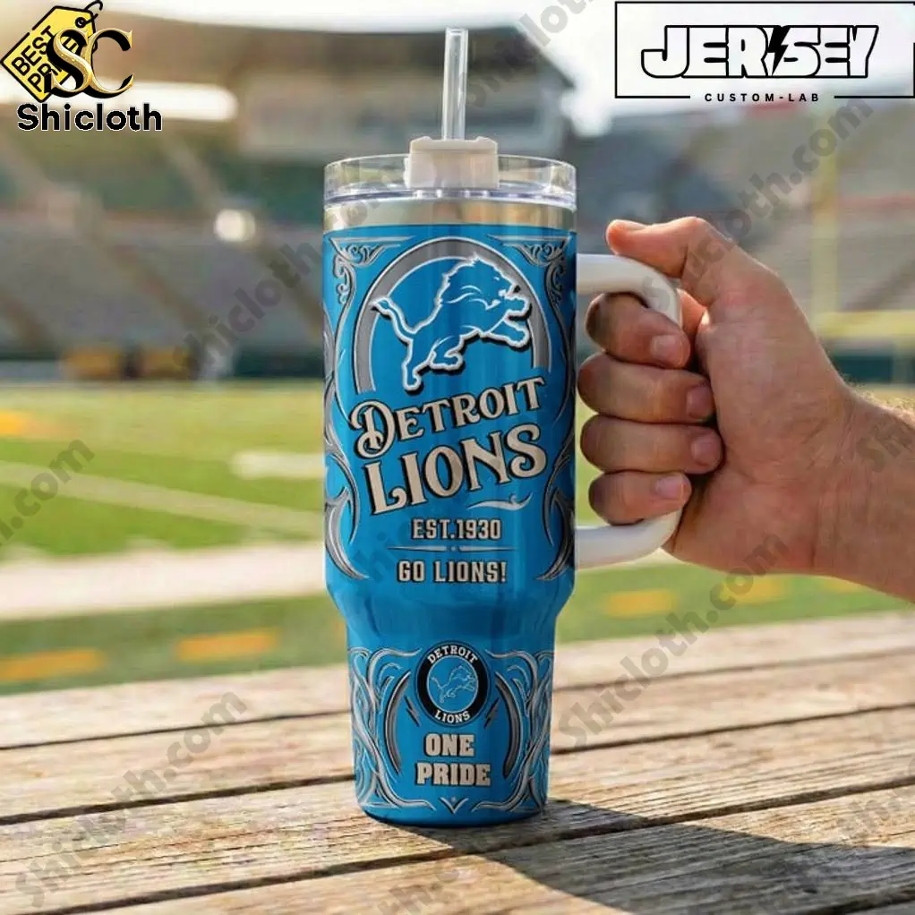 Hand holding Detroit Lions One Pride Special YETI Tumbler at football stadium.
