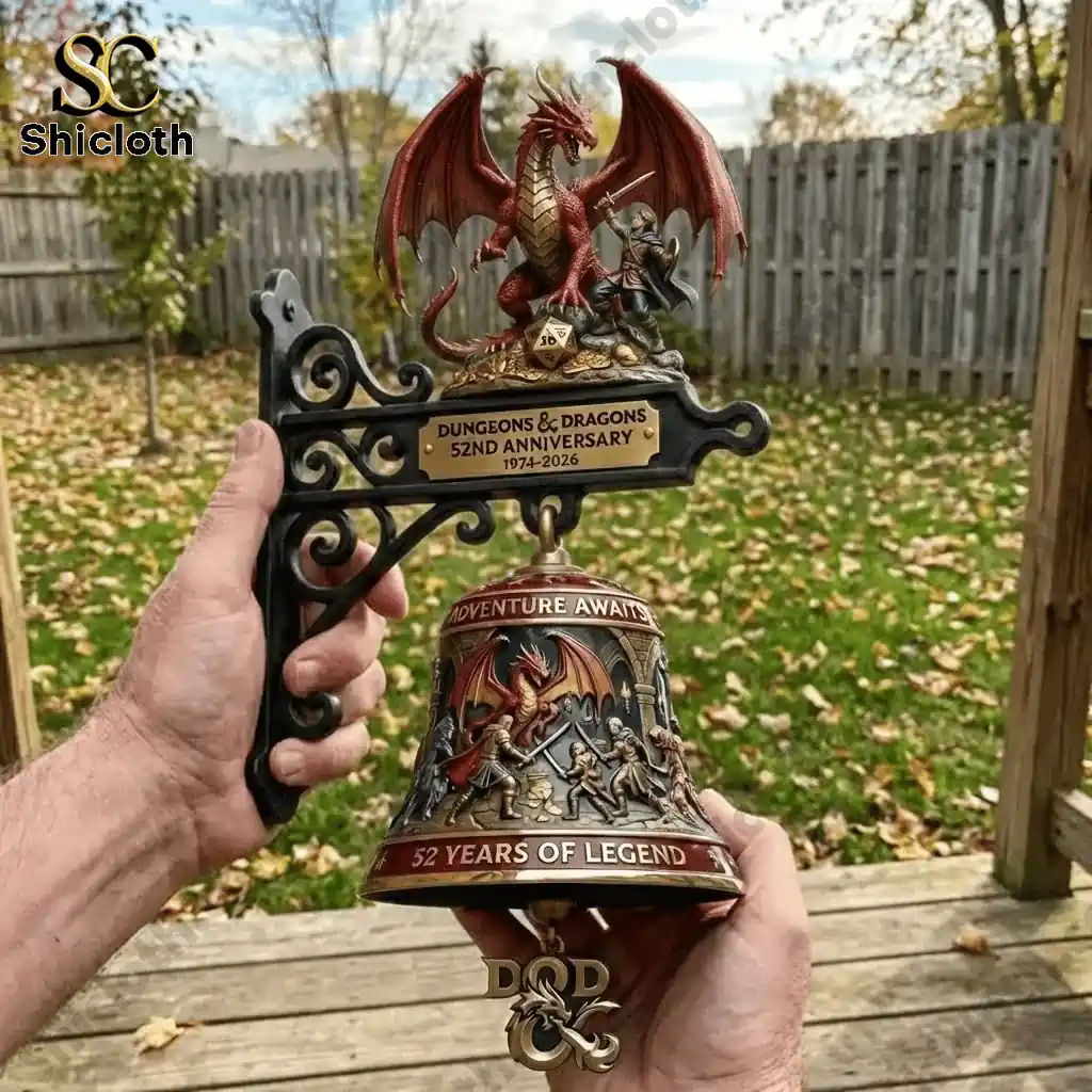 Hand holding Dungeons and Dragons 52nd Anniversary commemorative wall bell with dragon and warrior design outdoors