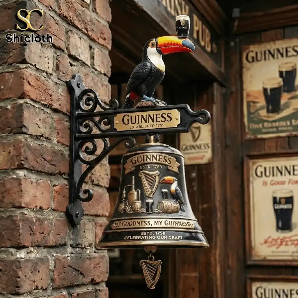 Guinness wall bell with toucan mounted on brick wall