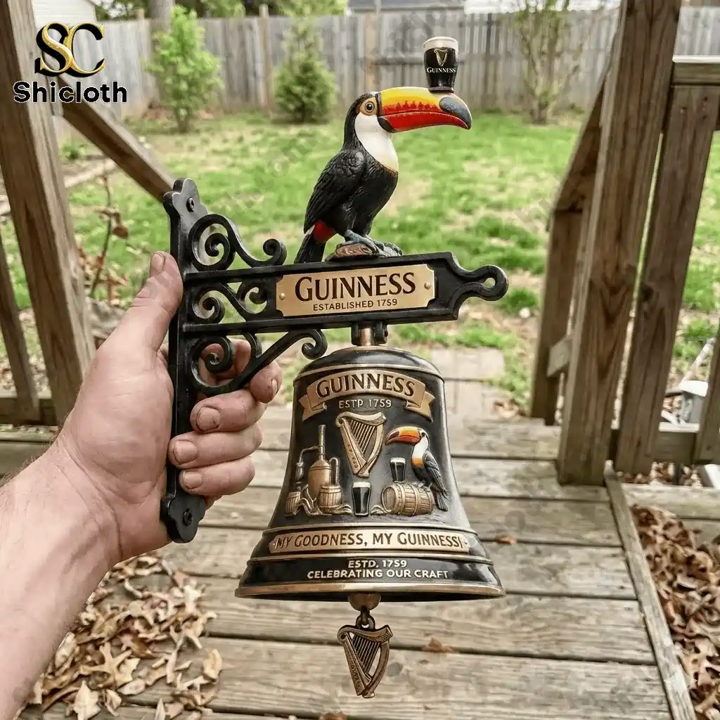 Hand holding Guinness toucan wall bell outdoors