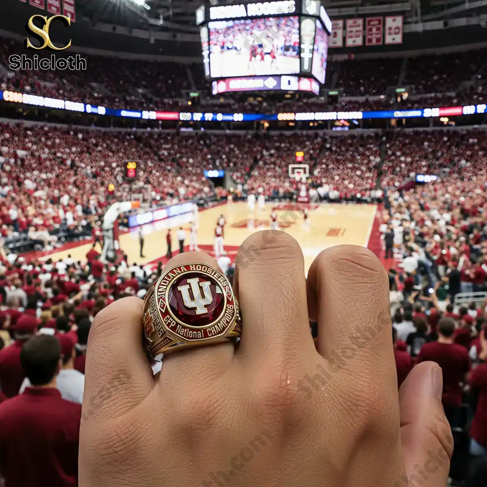 Hand holding up team champion ring inside packed arena!