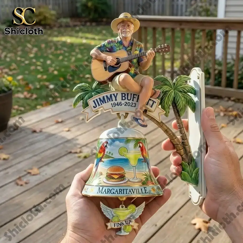Jimmy Buffett Margaritaville wall bell held in hands on wooden deck