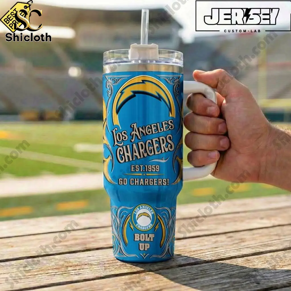 Close up of Los Angeles Chargers Bolt Up Special YETI Tumbler held at a football field.
