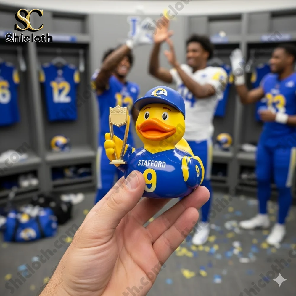 Alt text Rubber duck in Los Angeles Rams jersey holding a trophy in a locker room!