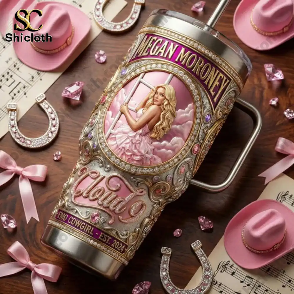 Megan Moroney Emo Cowgirl 40 OZ Tumbler 4 Pink decorative tumbler styled with cowboy hats and jewelry on a table!