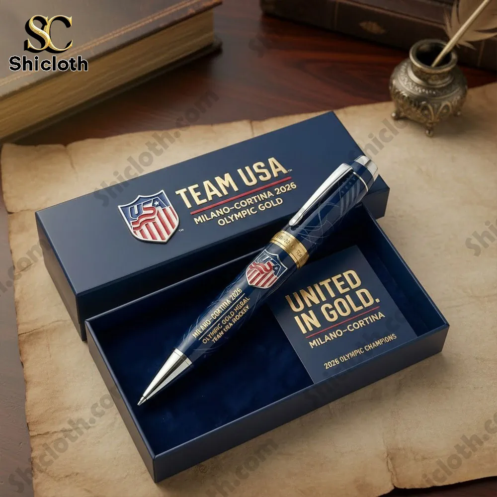 Open gift box displaying Team USA Milano Cortina 2026 Olympic Gold Medal pen with elegant blue and gold design.