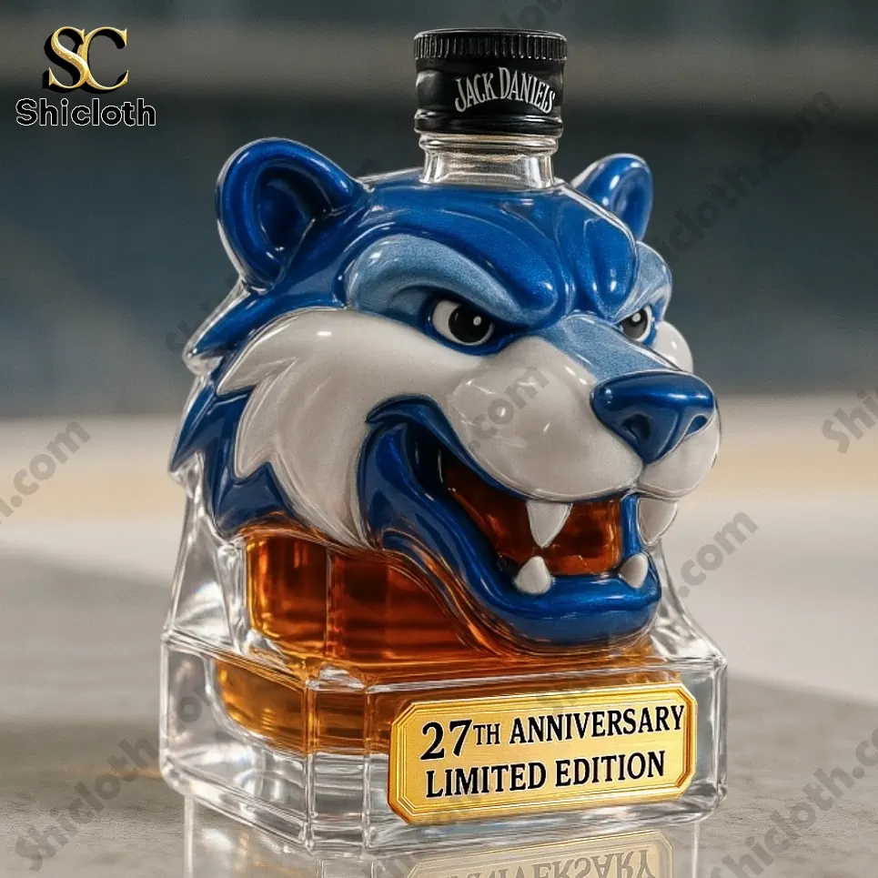 Blue sabertooth head whiskey bottle with Jack Daniels cap and anniversary label.