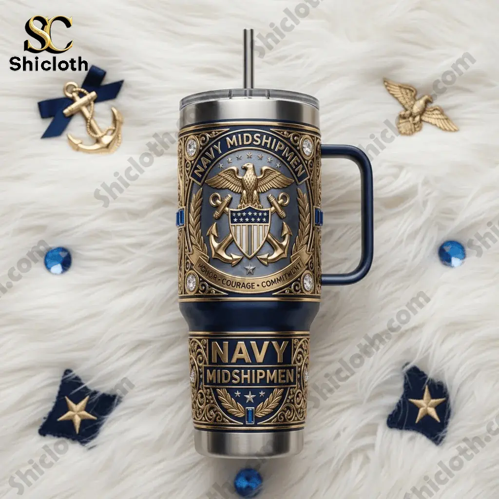 Navy Midshipmen Yeti Tumbler With Handle 3 Navy Midshipmen Yeti tumbler with handle photographed on a white fur background with navy themed items.