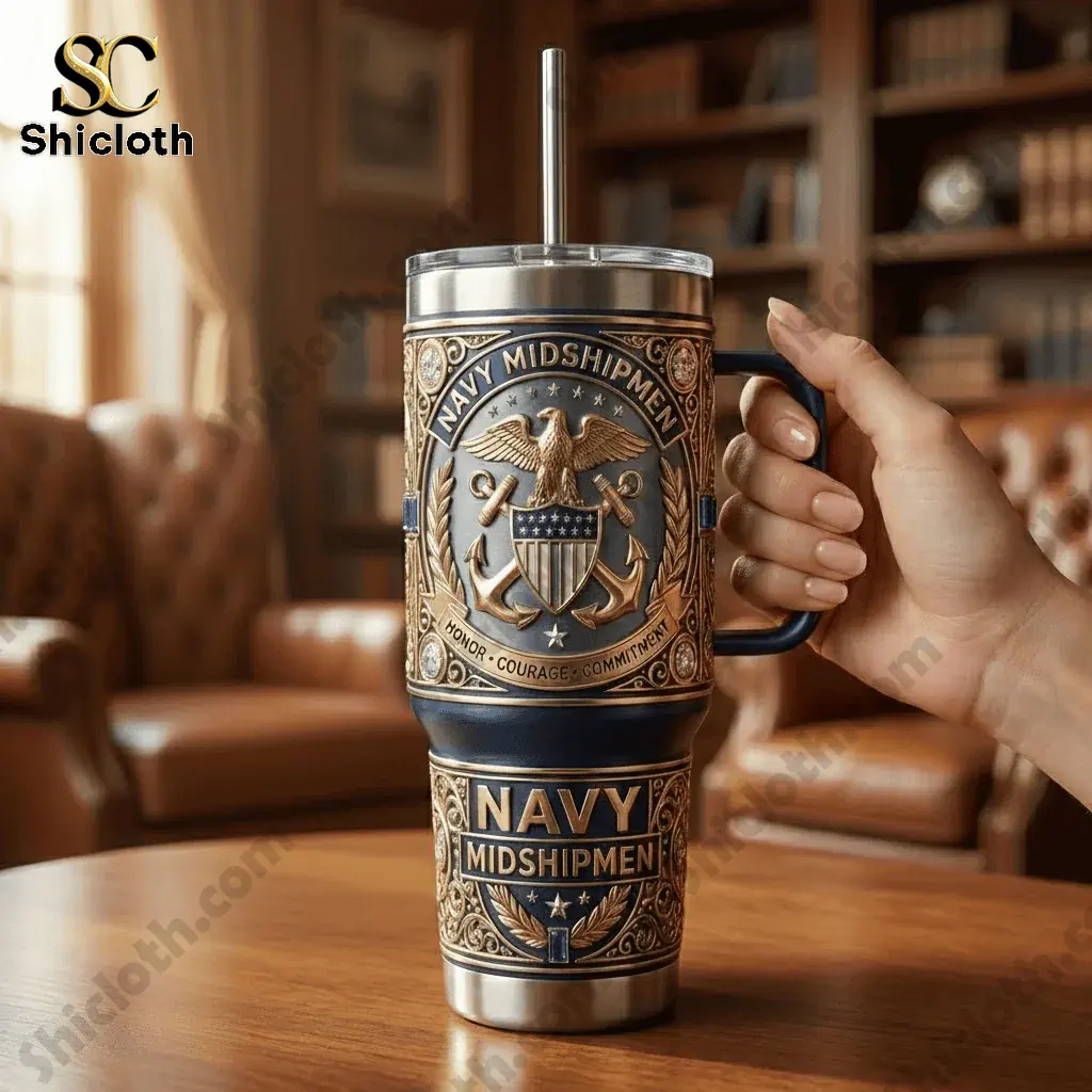 Navy Midshipmen Yeti Tumbler With Handle 4 Hand holding a Navy Midshipmen Yeti tumbler with handle on a wooden table in a cozy room.