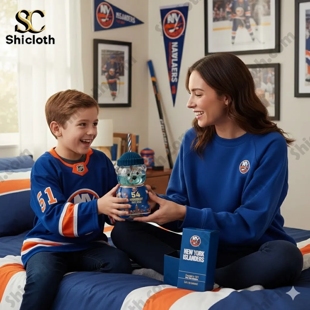 Mother and son smiling while holding a New York Islanders anniversary bear tumbler in a decorated bedroom!