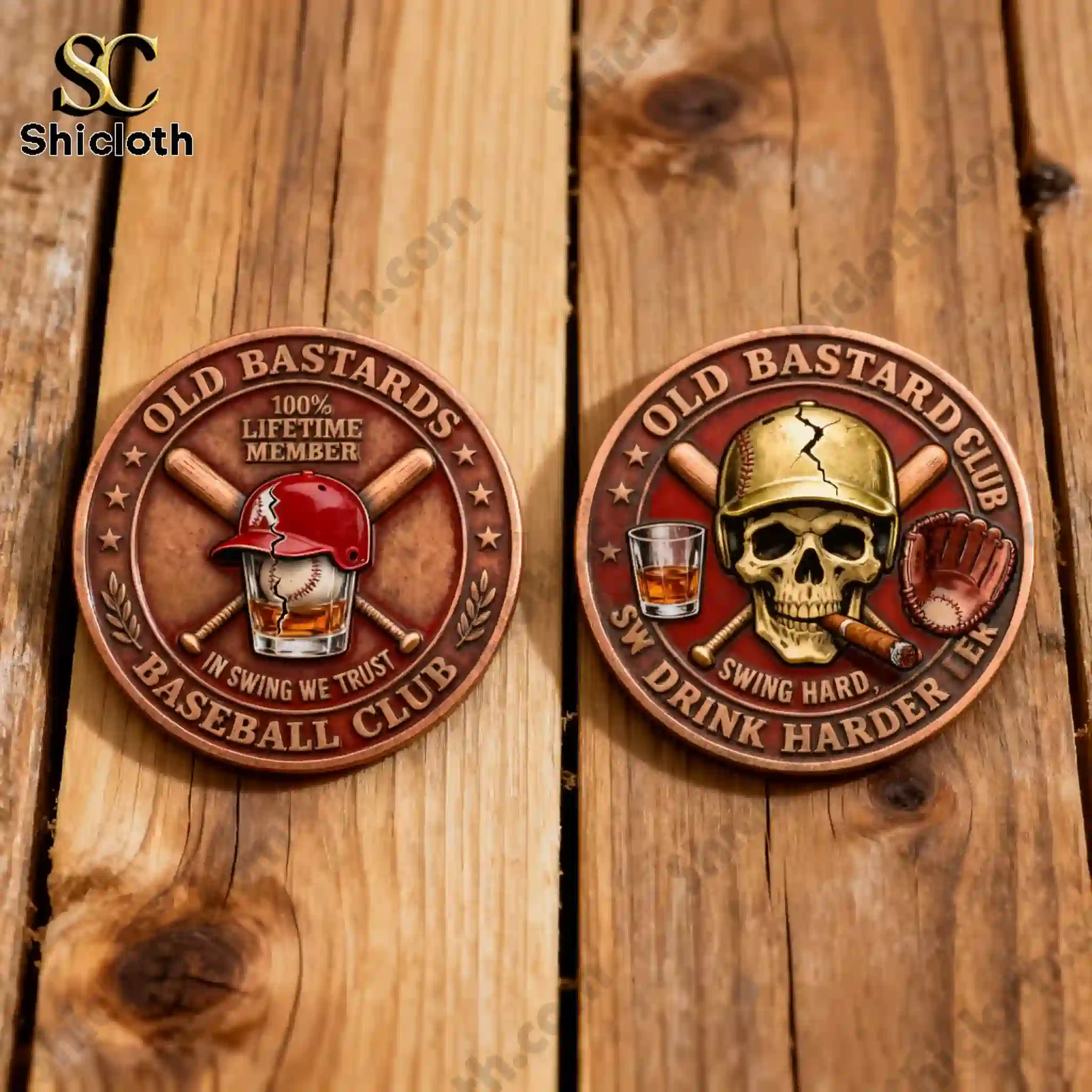 Two Old Bastards Baseball Club coins displayed on a wooden surface