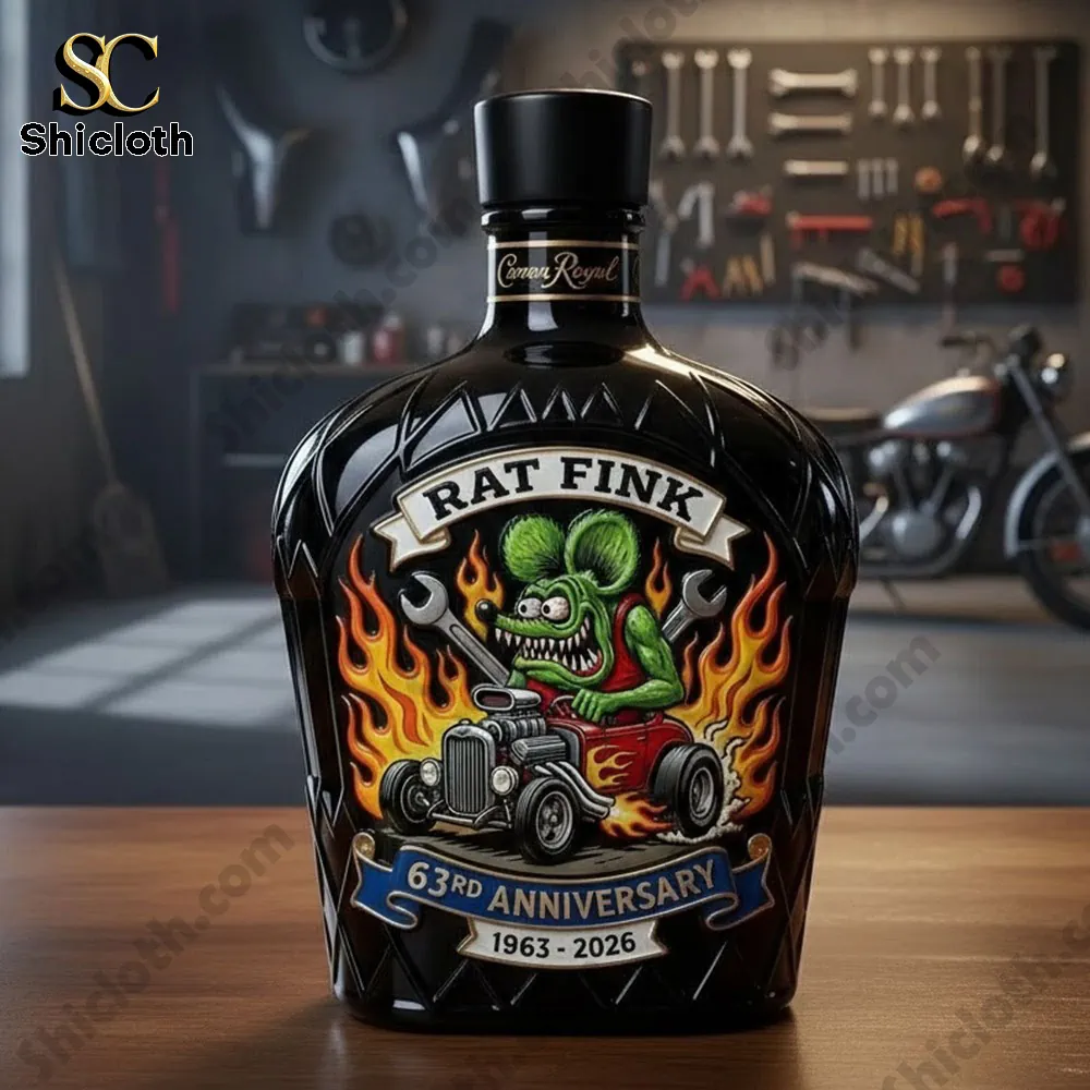 Rat Fink anniversary whiskey decanter displayed on a workbench in a custom garage.