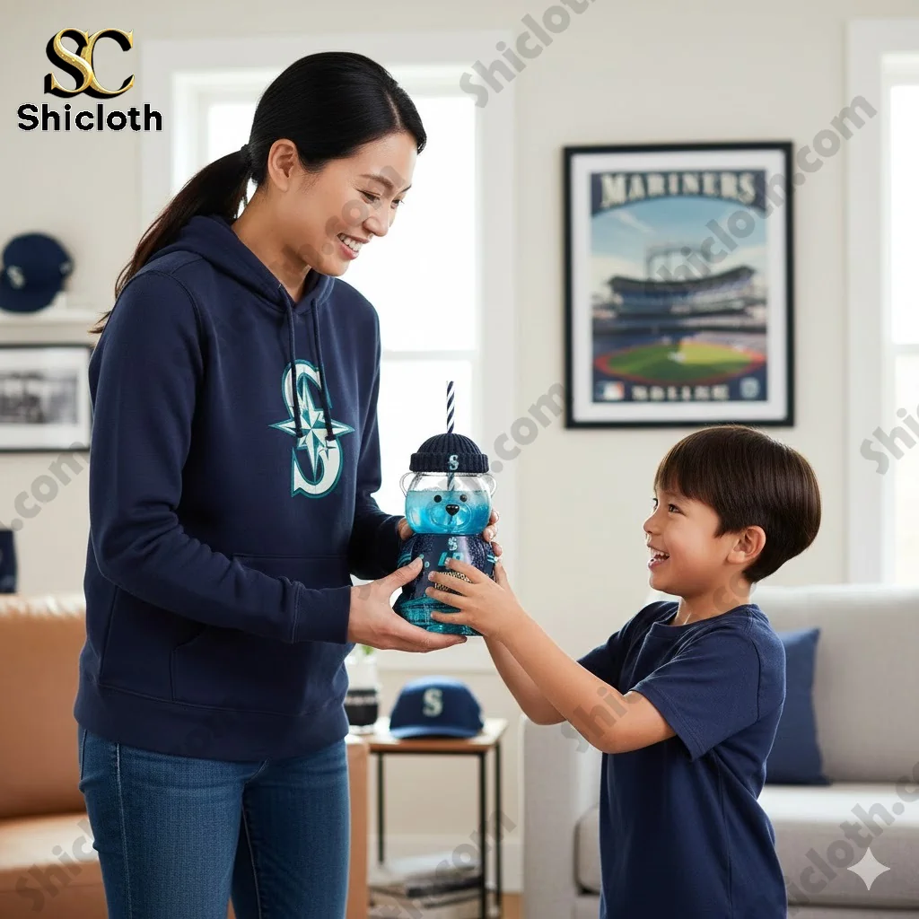 Mother and son holding a Seattle Mariners bear shaped anniversary cup.