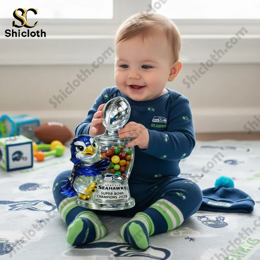 Baby holding Seahawks themed candy jar toy!