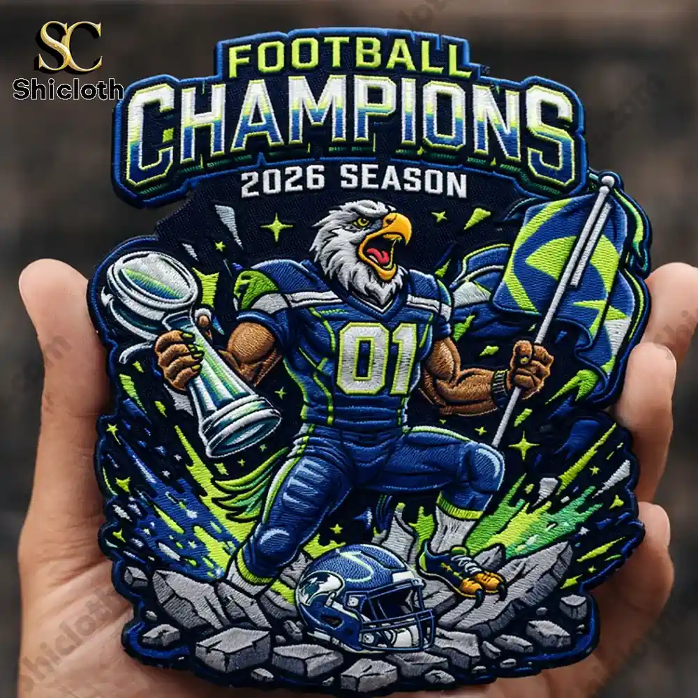 Embroidered Football Champions 2026 patch with eagle player holding trophy and flag.