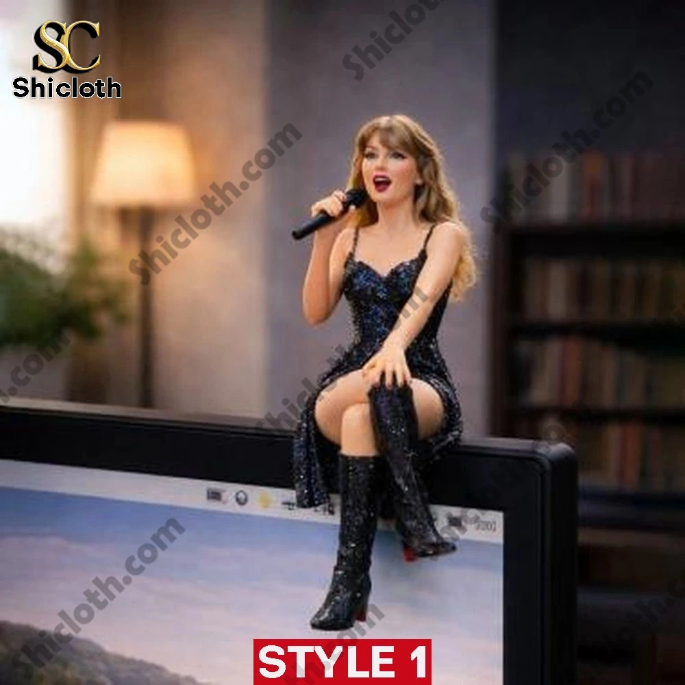 Taylor Swift style figurine in black dress sitting on a computer screen holding a microphone.