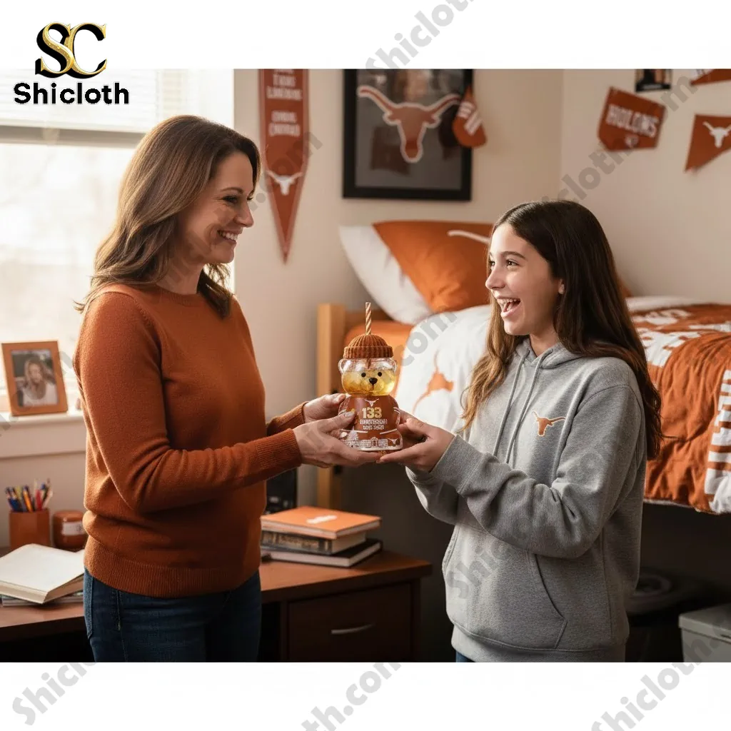 Mother giving Texas Longhorns Anniversary Bear Cup to her daughter in a Longhorns themed bedroom.