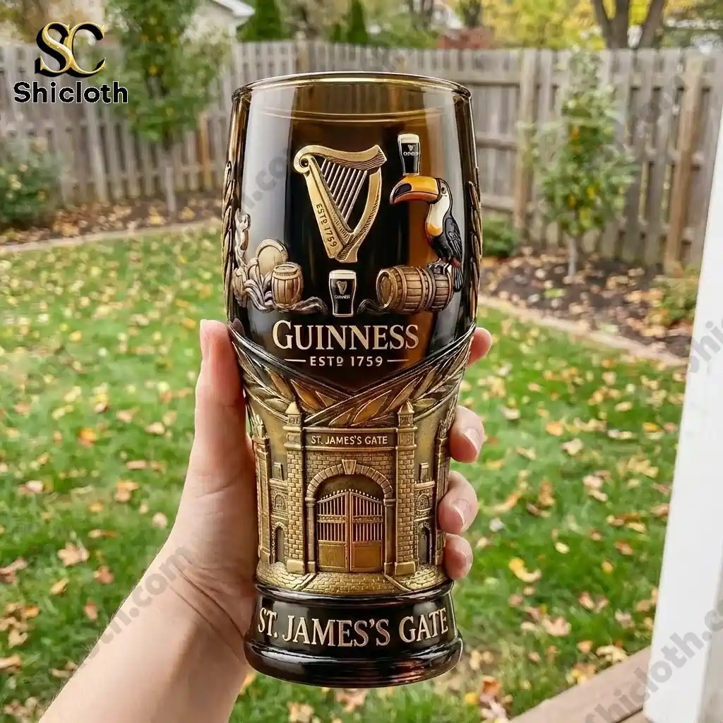 Hand holding Guinness St James Gate heritage glass outdoors with garden background!