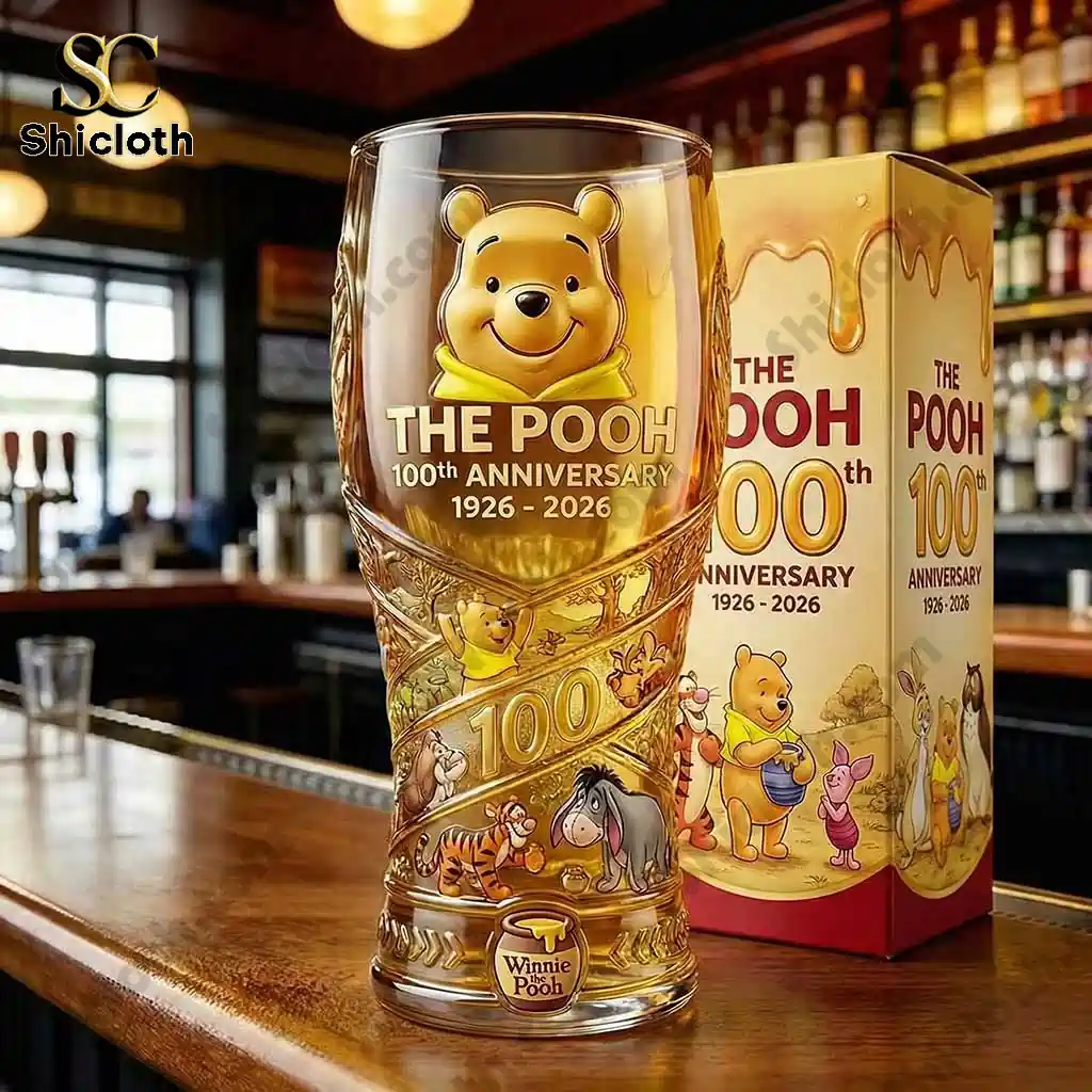 Close up of The Pooh one hundredth anniversary glass with themed box on bar counter!