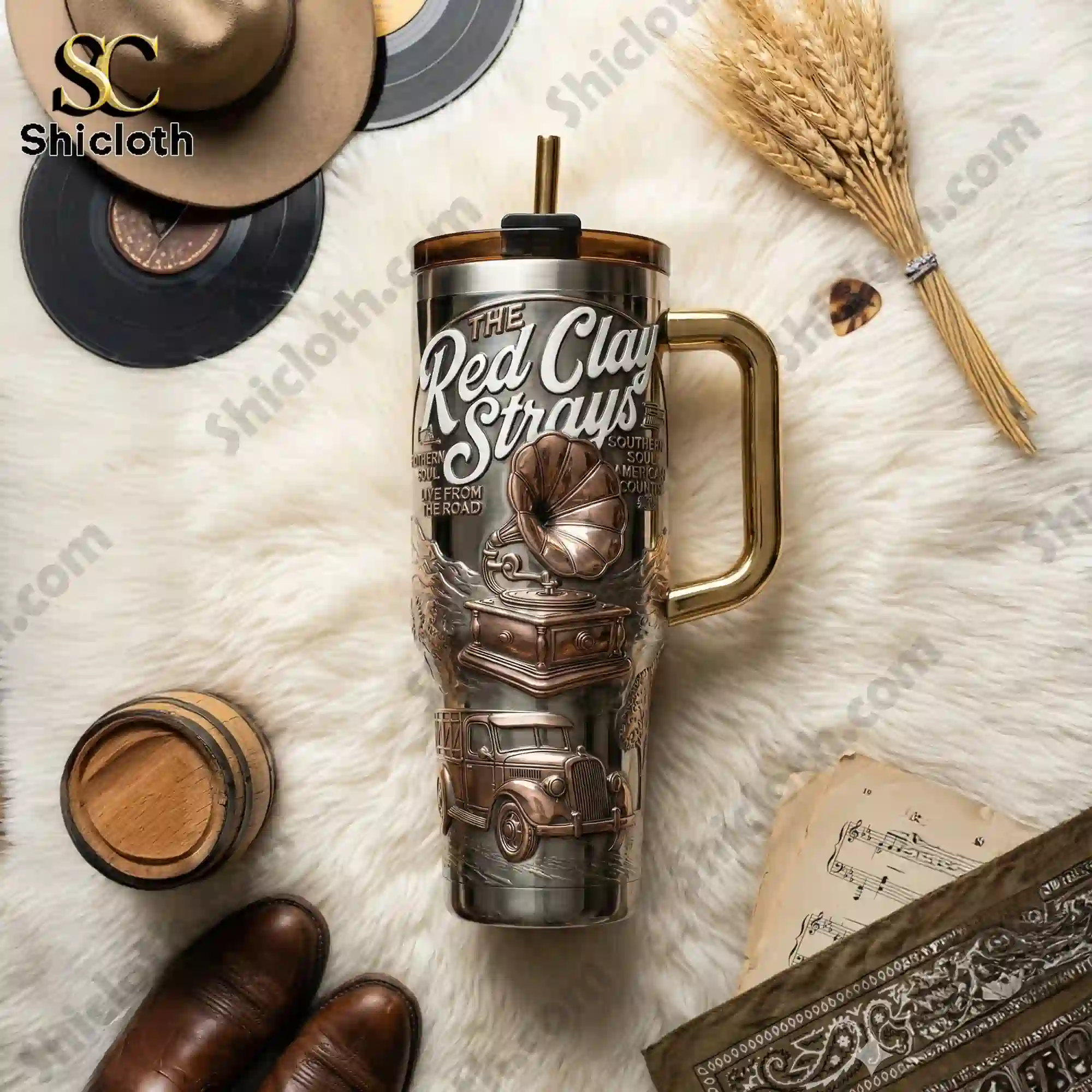 The Red Clay Strays Wondering Why 40oz Tumbler With Handle 4 The Red Clay Strays tumbler with handle placed on white fur with vinyl records and country accessories