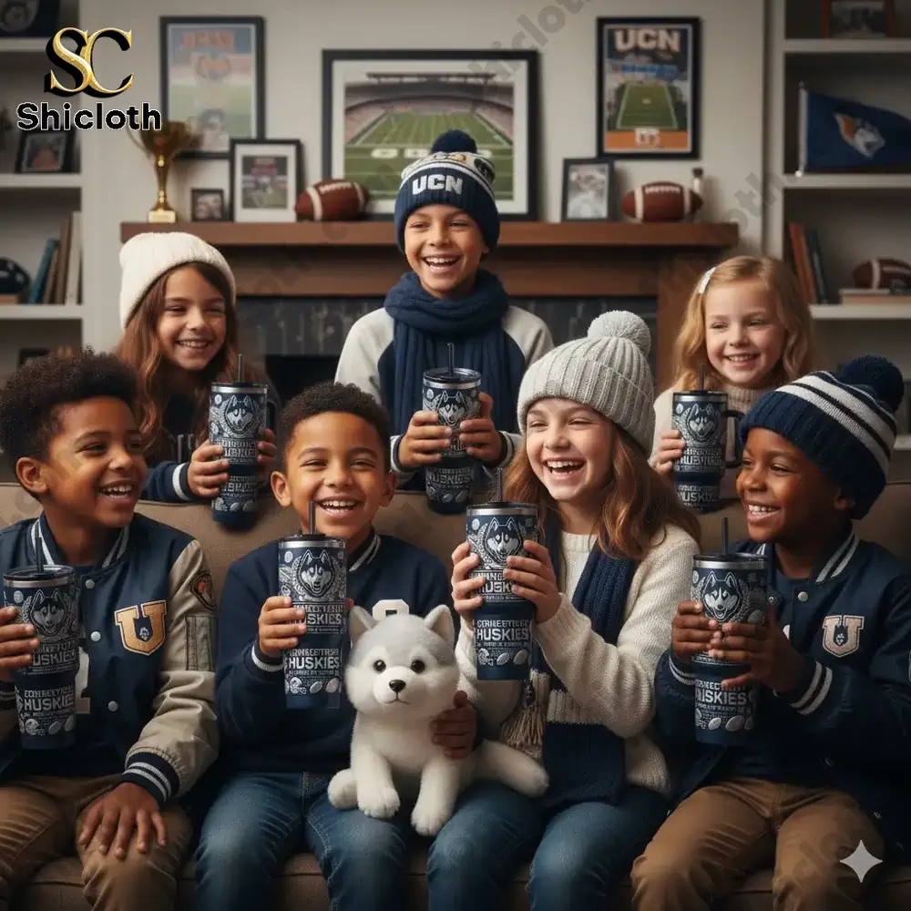 Smiling children holding Connecticut Huskies tumbler in cozy fan room!