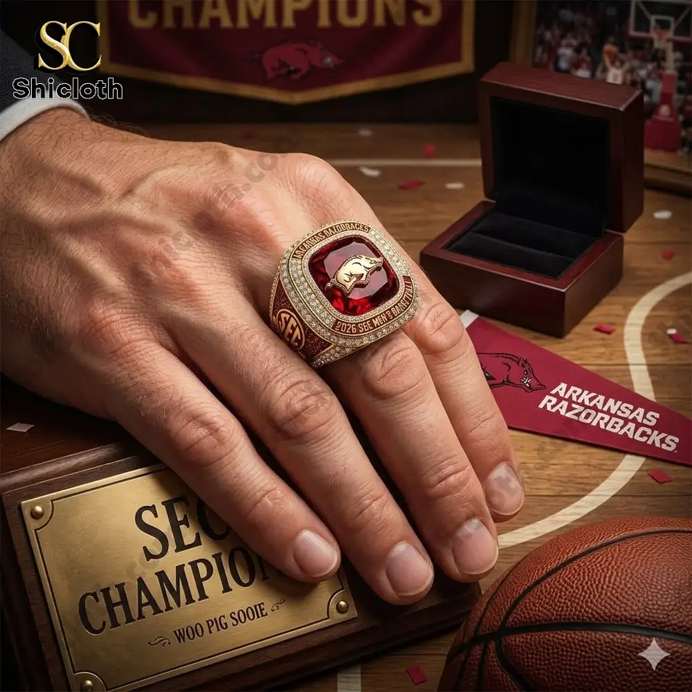 Hand wearing Arkansas Razorbacks championship ring on basketball court