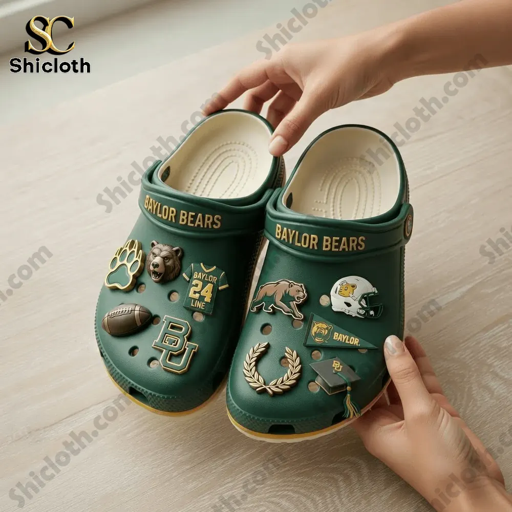 Hand holding green Baylor Bears clogs with detailed charms
