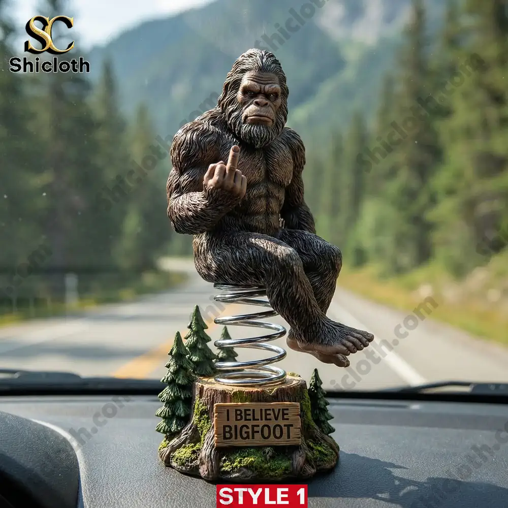 Bigfoot dashboard bobblehead sitting on spring base with I believe Bigfoot sign in car!