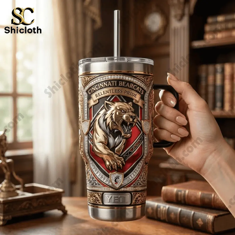 Hand holding Cincinnati Bearcats Yeti tumbler in classic room