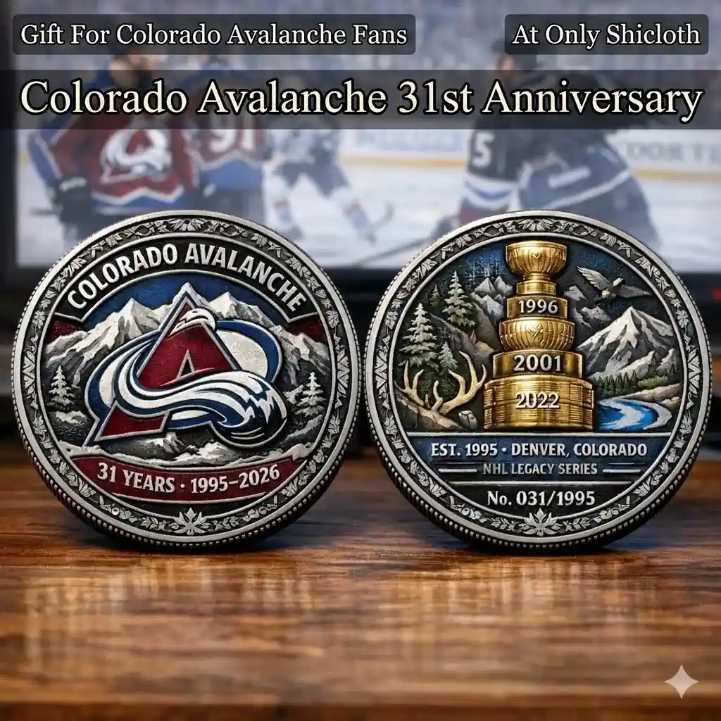 Colorado Avalanche thirty one years anniversary legacy coin showing front logo and back championship cup design on wooden table!