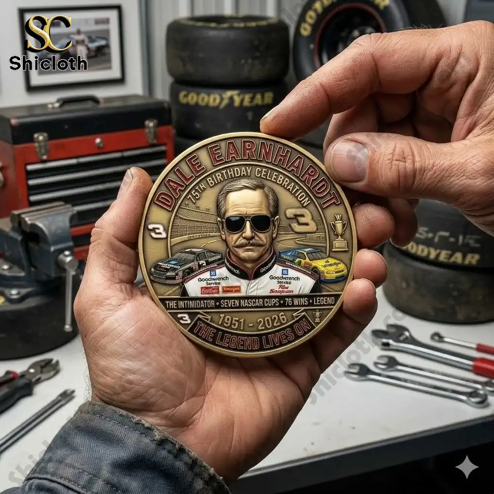Hands holding Dale Earnhardt commemorative coin in workshop