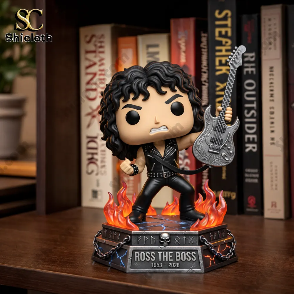 Rock star figure holding guitar on fiery base on bookshelf!